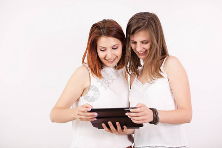 两个美女的肖像拿着一张平板电脑看图片