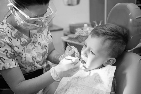 一个小男孩在牙科诊所的牙医招待会上儿童牙科儿童牙科黑白复古风格摄影口图片