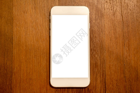 在木桌背景上带有空白桌面屏幕的白色手机的顶图片