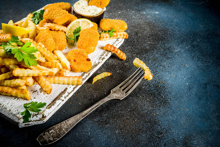 英国传统快餐垃圾食品英国菜鱼和薯条配鞑靼酱柠檬和蔬菜图片