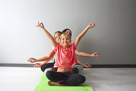 年轻女和孩子一起做瑜伽玩得开心图片