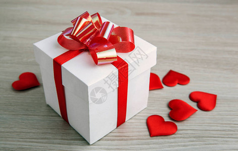 灰色背景上的白色礼物盒和纺织心脏形图片