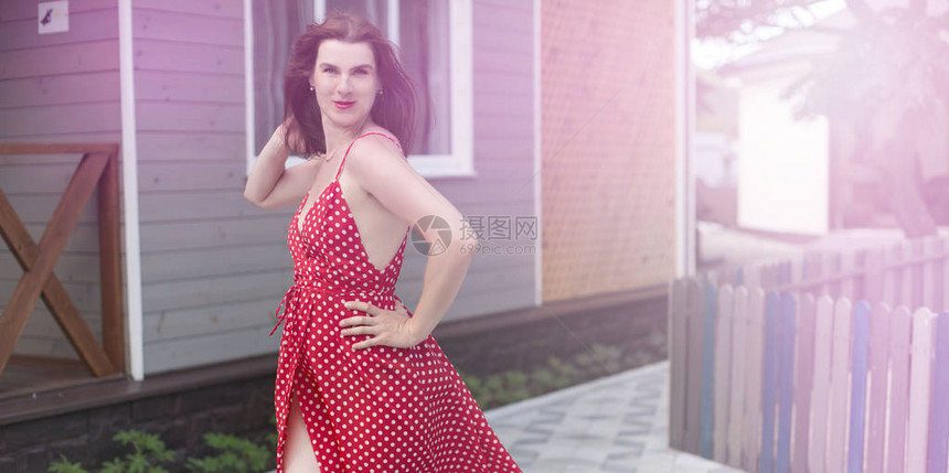 在街上走在欢乐街头的年轻女子笑着快乐微笑穿着红裙子的布朗特图片