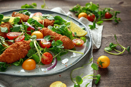 新鲜沙拉加鸡块樱桃西红柿和绿色蔬菜图片