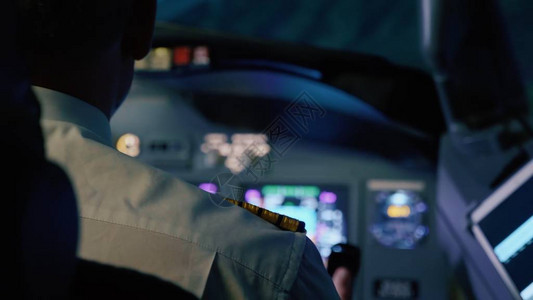 机长在晚上控制飞机后视驾驶员在图片