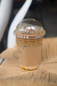 焦糖玛奇朵冰咖啡放在木桌上图片