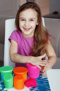 一个小女孩在玩塑料和粉红色红色和绿色的杯子图片