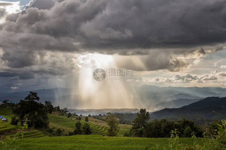 暴风雨云雨和阳光在山上图片