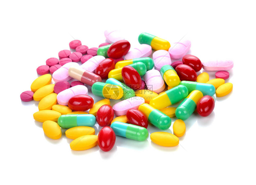 白色背景上的彩色药丸和药片图片