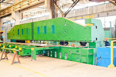 金属加工的业生产设备该设备大而重的绿色带有用于接收和传输备件传送带的图片