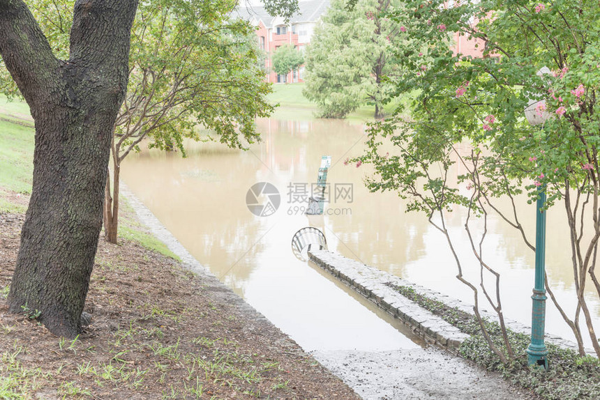 美国得克萨斯州达拉斯福特沃斯市郊区道路附近的热水狗废物处理站和户外钢垃圾箱暴雨淹没图片