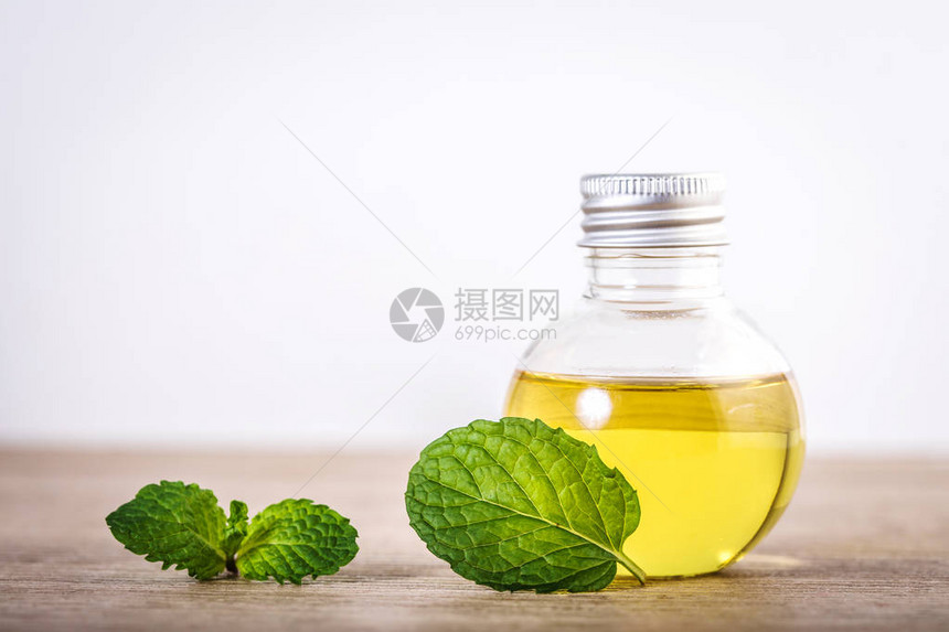 用新鲜绿薄荷叶在桌上的瓶子上用薄荷粉中的阿图片