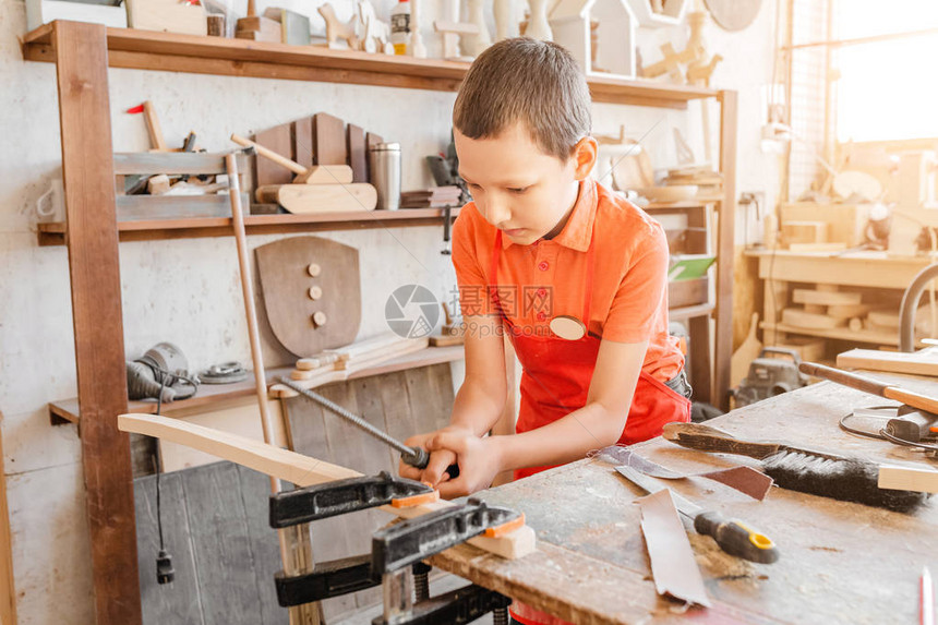才华横溢的天才小男孩在木工车间用木头工作儿童学习爱好和手图片
