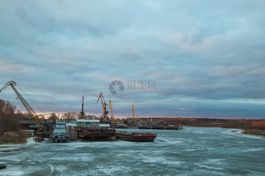 有货船的码头在结冰的河上图片