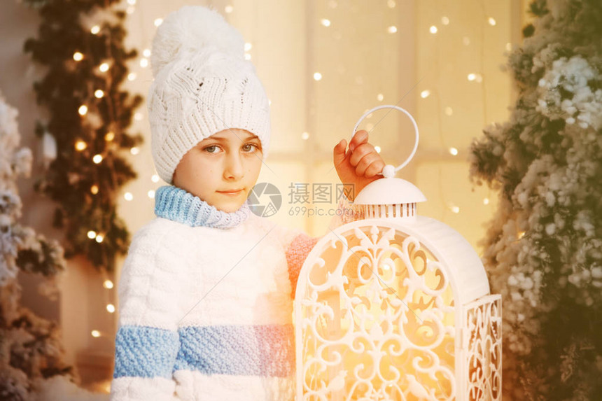 穿着白色和蓝色毛衣的男孩戴着白帽子在圣诞节日附近图片