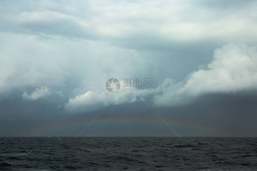 风雨如磐的海面上的彩虹图片