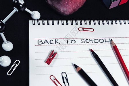 黑背景的红黑和白学校用品构成返回学校概念顶级视图您可以使图片