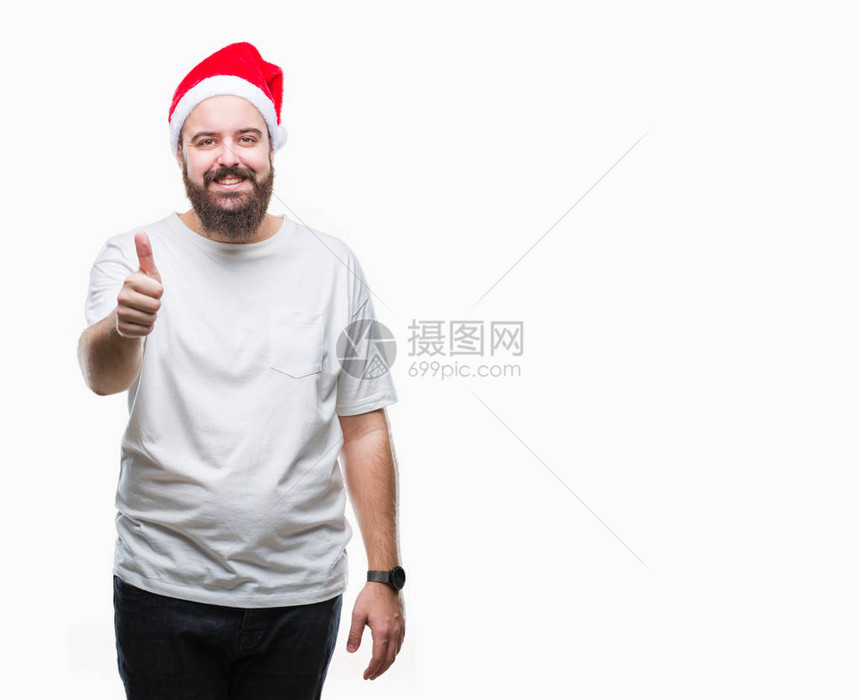年轻的白种人时髦男子戴着圣诞帽图片