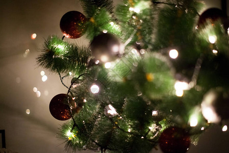 圣诞树上的灯光和圣诞玩具背着模糊图片