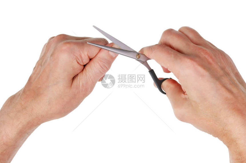 老人用钢剪刀切旧指甲在白色工作室的顶图片