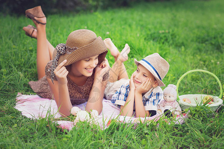 小男孩和少女在草地上野餐图片