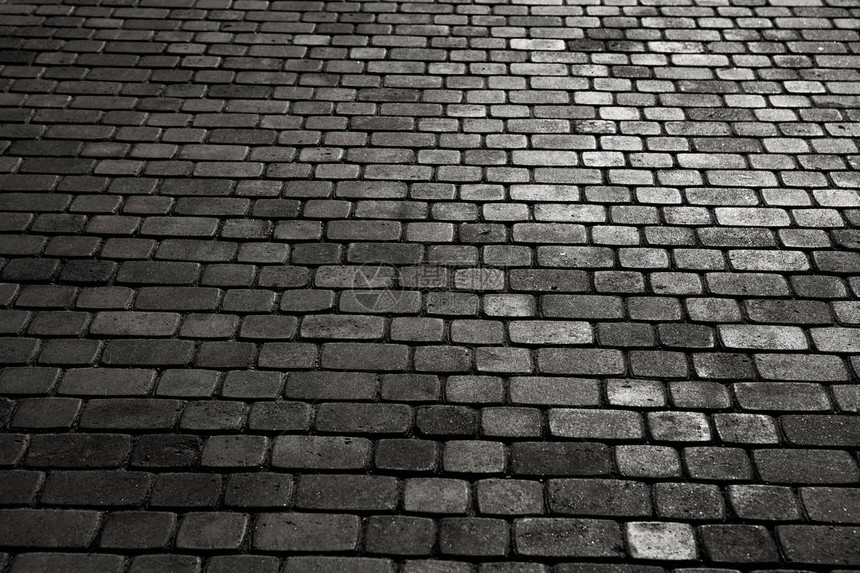 铺有斑岩立方体的城市鹅卵石的质地一条街道的地板与石瓦片花岗岩鹅图片