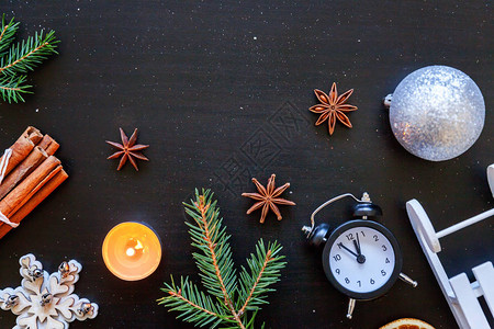 圣诞新年作文冬季对象时钟雪橇冷杉树枝小玩意深黑色背景上的球图片