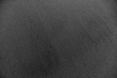 海滩上的黑沙火山纹理背景图片