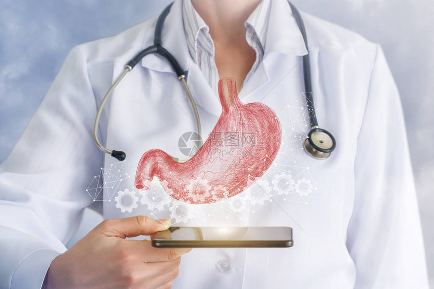 齿轮方案中的数字胃模型悬挂在医生手中的设备上方概念是技术在内脏图片