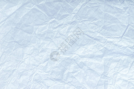 折叠白包装纸的纹理特写浅蓝色旧背图片
