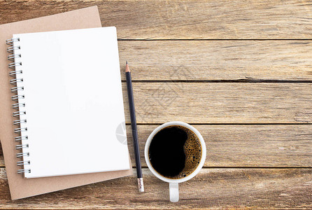 棕色木桌背景上的空白纸笔记本铅笔和咖啡图片