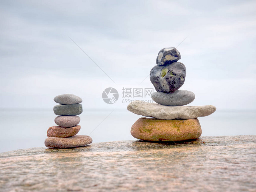 在海滨上堆满圆形石头的堆积物在石块沙图片
