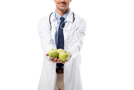 医生将新鲜苹果握在孤立的手中图片