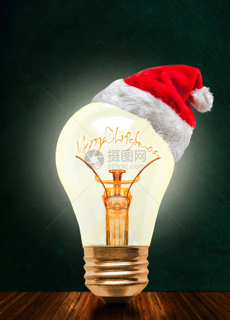 发光的灯泡戴着圣诞老人的帽子图片