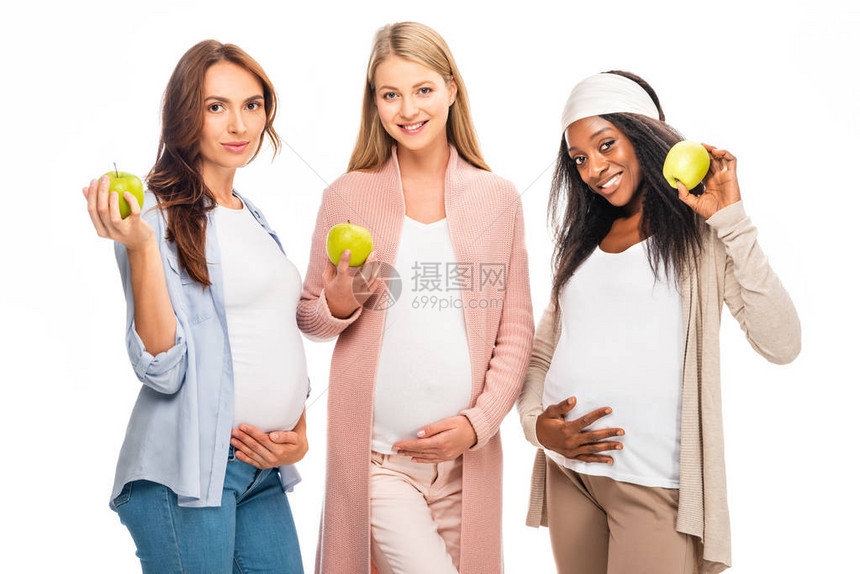怀着微笑的孕妇将水果握在白图片