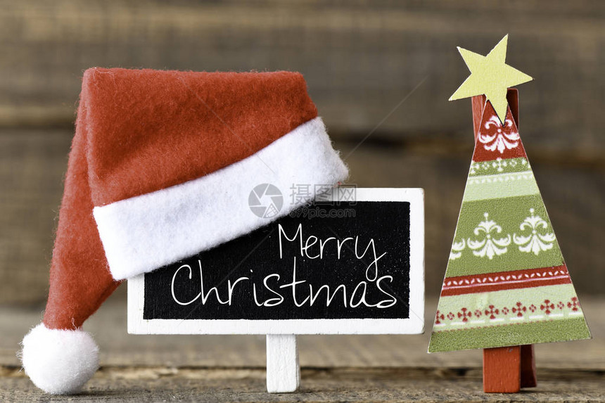 圣诞快乐文字写在小黑板上面有圣诞帽子和图片