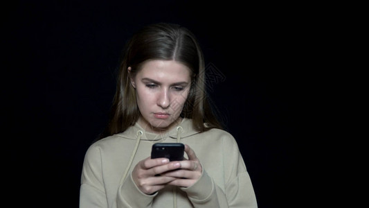 年轻女子阅读消息收到智能手机的通知有吸引力的女人图片