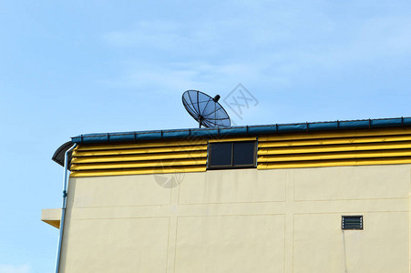 房屋顶上的卫星天线背景蓝天黑色卫星天线或电视天线的图片
