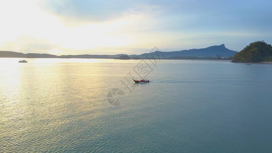 长尾帆船在夏日夜晚朝公海航行图片