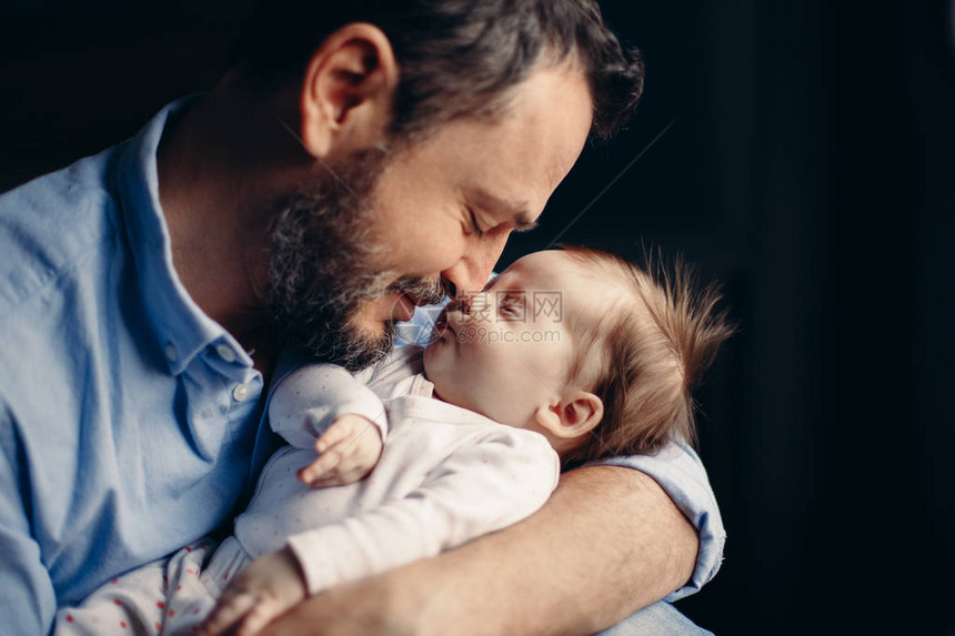 中年大胡子白人父亲拥抱和亲吻新生婴儿的特写肖像男父母抱着孩子真实的生活方式感人的温柔时刻单身爸图片