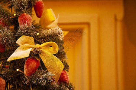 圣诞树上装饰着草莓蝴蝶结和丝带图片