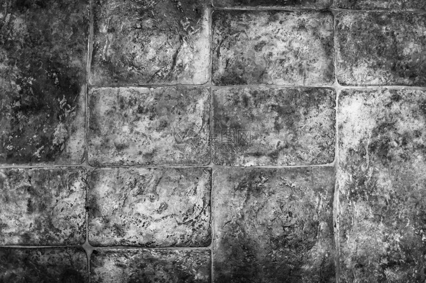 黑色和白色的石工纹理地板上的石块设图片