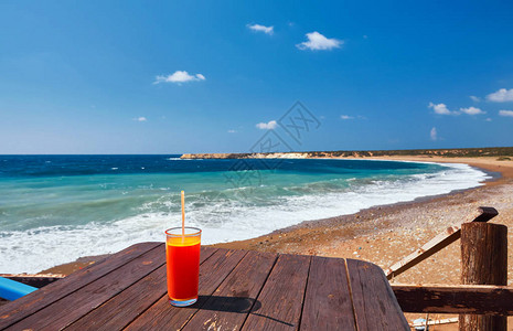 木制桌上的橘子鸡尾酒在地中海附近阳背景图片
