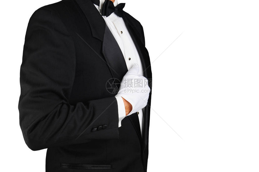 一个男人穿着燕尾服和拿着他的翻领的白手套的特写镜头白色的水平格式图片
