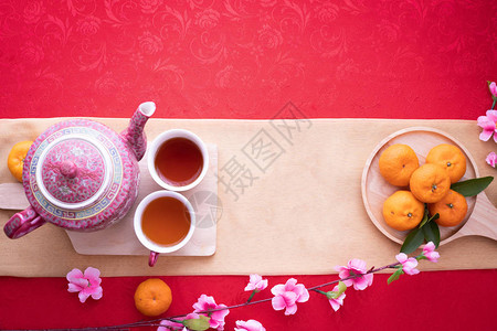 橙色水果粉红樱花和茶壶图片
