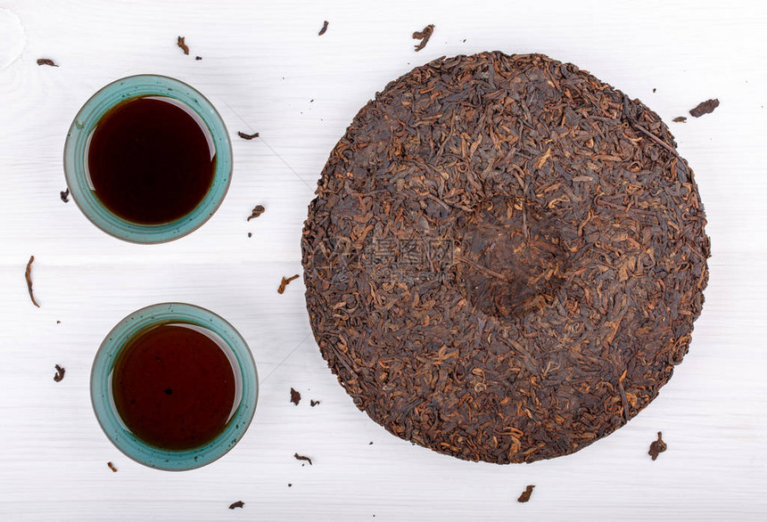 圆盘平面杯茶和两杯白茶按下发酵的Puerh茶图片