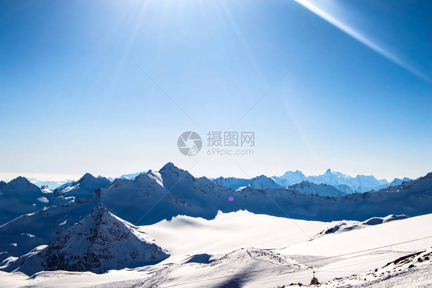 雪峰背景的滑坡部分在阳光明媚的日子里高加索山脉图片