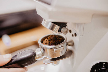咖啡师使用咖啡机研磨咖啡豆图片