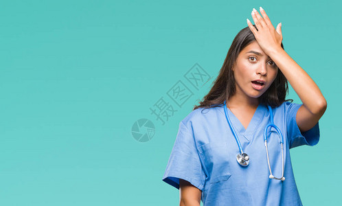 年轻的阿拉伯医生外科医生女人在与世隔绝的背景下惊讶地用手捂着头图片