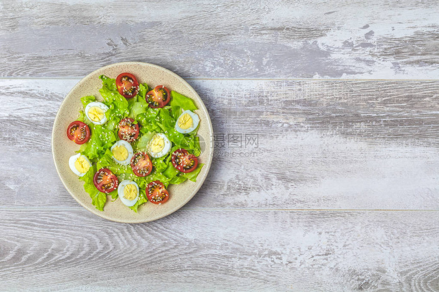 新鲜健康沙拉配有生菜蛋樱桃西红柿和芝麻盘顶端视图片